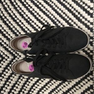 Black Dansko sneakers with zipper on side, white sole.